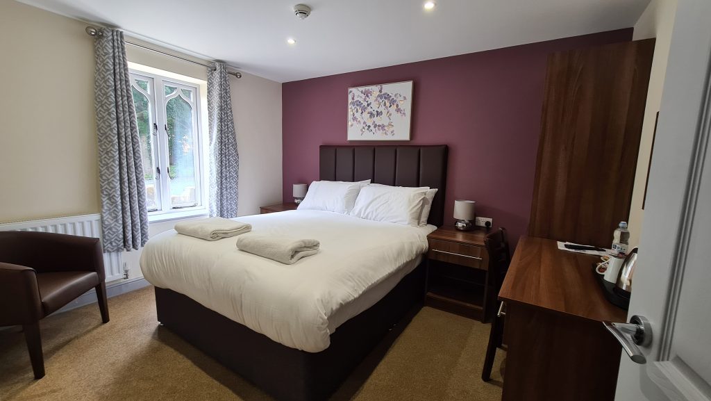 King room at The Lemon Tree hotel in Wrexham with a king-size bed, armchair and window
