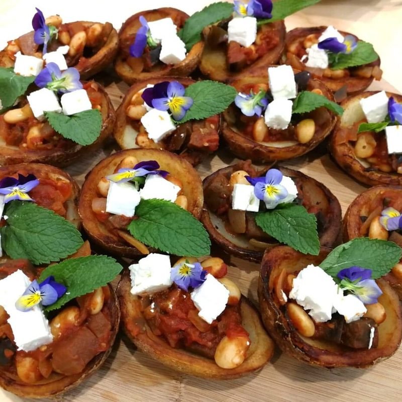 Feta and tomato tartlets with edible flowers