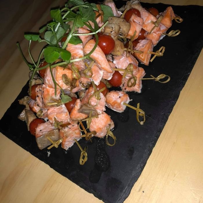 Salmon and tomato skewers on a slate